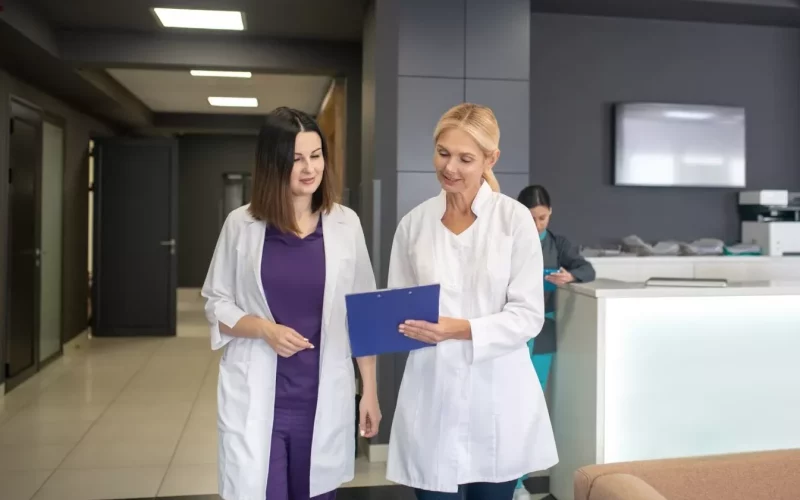 Two doctors talking in the clinic corridor