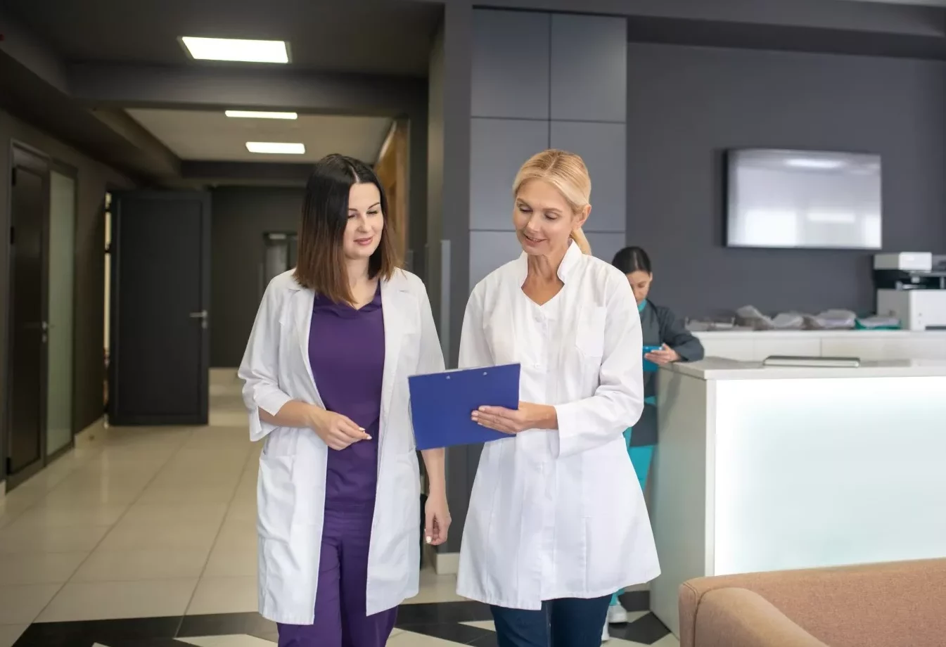 Two doctors in conversation in the clinic corridor