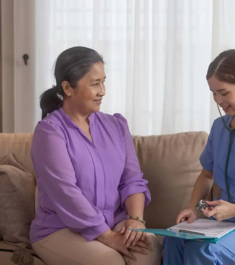 A clinician assessing a patient during a home visit